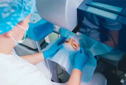 Doctor getting ready to perform a surgical procedure on a woman's eyes