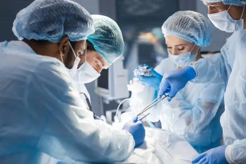 Surgeons and nurses working on a patient in an operating room