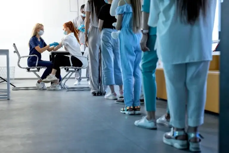 People receiving and standing in line for vaccinations