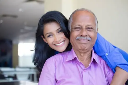 Woman holding father her head is on his shoulder