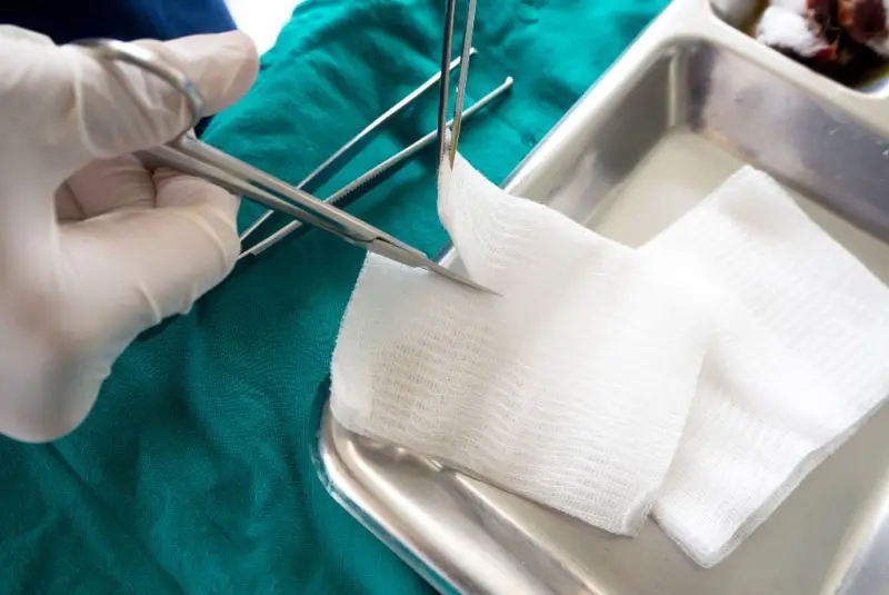 Close up of surgeon cutting gauze