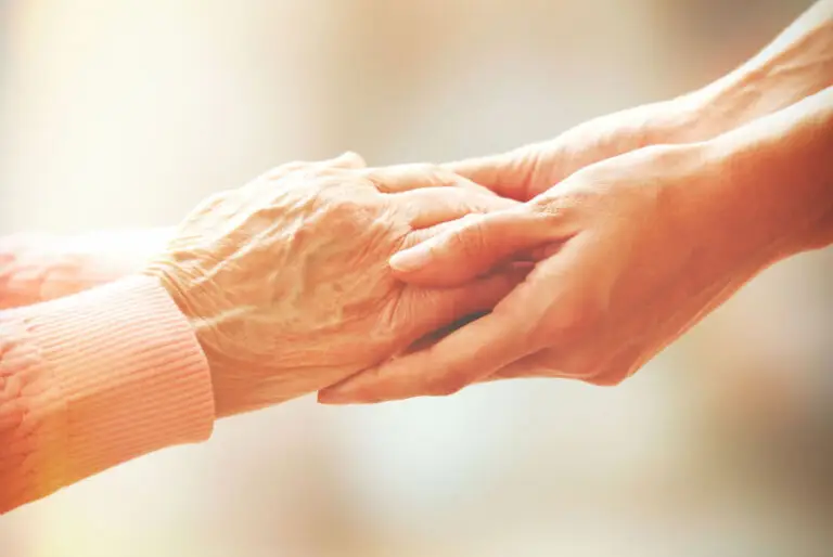 A younger set of hands holding an older set of hands