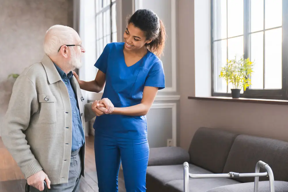 Nurse helping a patient walk