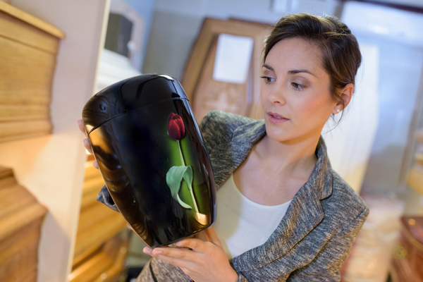 Woman holding an urn and looking at it